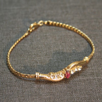 Gold tone Bracelet with Red/Brown stone
