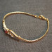 Gold tone Bracelet with Red/Brown stone